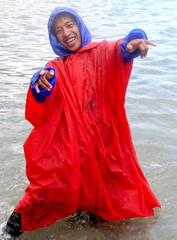 beach boy in poncho